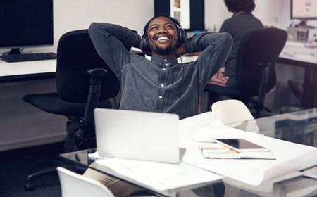 As happy as an architect can be. a handsome young male architect smiling while sitting with his...