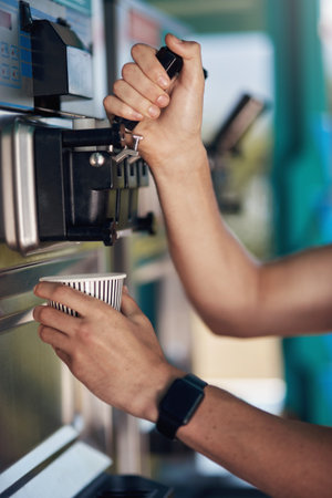 Another hot coffee on the way. an unrecognisable coffee barista pouring a cup of coffee to serve to a customer outside next to his coffee truck.の写真素材