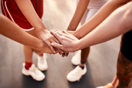 1, 2, 3 go team. an unrecognizable group of sportswomen piling their hands together before a basketball game.の写真素材