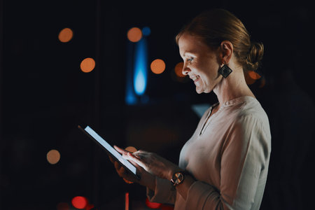 The world online never sleeps. a young businesswoman using a digital tablet outside an office at...