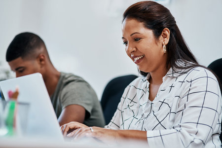 The internet, the greatest business resource. a young businesswoman using a computer in a modern...