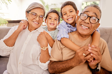Love, happy family and kids relax with grandparents on a sofa, hug and bonding in a living room....