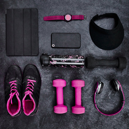 I think I came prepared. High angle shot of a group of workout essentials lying on top of a dark background inside of a studio.の写真素材