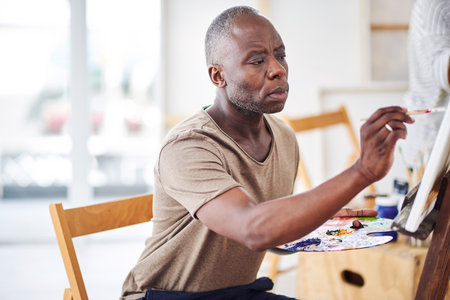 To paint is to show a bit of your soul. a man painting in a art studio.の写真素材