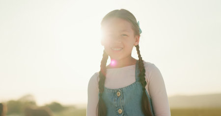 Happy, little girl and smile for agriculture, countryside or travel in summer vacation enjoying time...