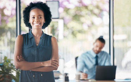 Ceo, business and manager working as management at an executive corporate company. Portrait of a black woman, worker or boss with arms crossed, pride and smile for happiness at a professional officeの写真素材