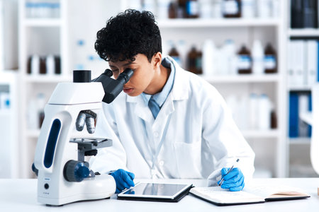 The expert will solve it. a young scientist using a microscope in a lab.