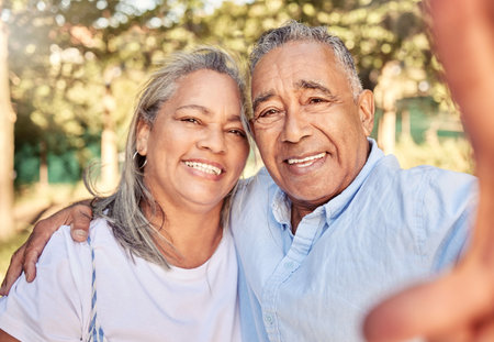 Selfie, portrait and senior couple in a park for love, care and happiness during retirement together. Happy, smile and elderly man and woman with a photo in nature, garden or environment in summerの写真素材