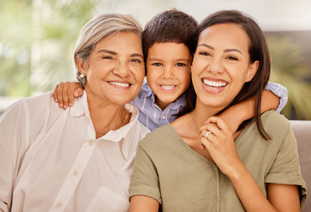 Happy, mother and grandmother with child hug relaxing on living room sofa with smile at home....