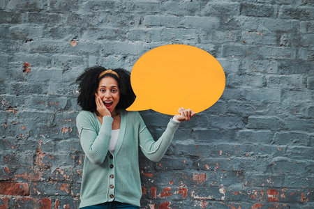 Social media, wow and woman with speech bubble against a wall in city for marketing, business and...