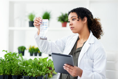 I have a strong interest in plants and science. a scientist using a digital tablet while working in a lab.の写真素材