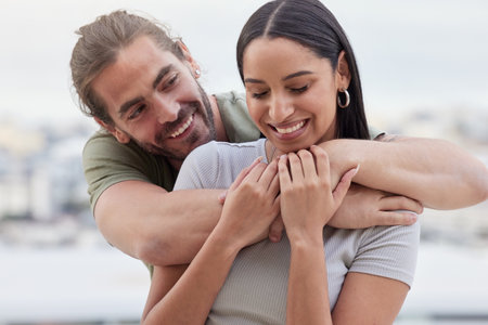 Care, interracial and hug for love in couple relationship with happy woman holding hands of man. Indian girlfriend of caucasian partner enjoying bonding embrace for affection together in Canada.の写真素材