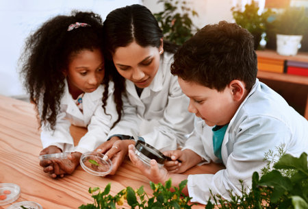 Everything grows with patience. an adorable little boy and girl learning about plants with their...