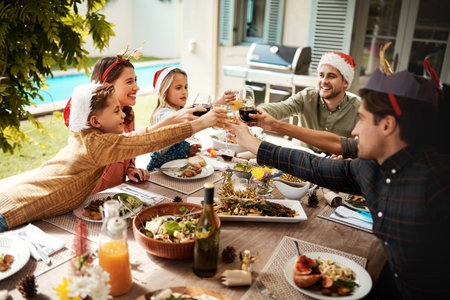The best gift around the Christmas tree is family. a family making a toast on Christmas day.の写真素材