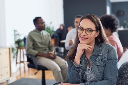 We did it as a team. Portrait of a young businesswoman having a meeting with colleagues in a modern...