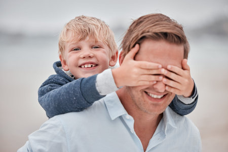 Family, face and father and son at a beach with hands covering dad eyes for surprise, guess and...