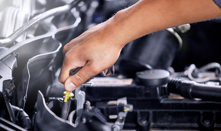 Engineering, repair and mechanic working on a car, doing a service and check for problem with the engine at a workshop. Hands of a transportation technician doing maintenance on a van or vehicleの写真素材