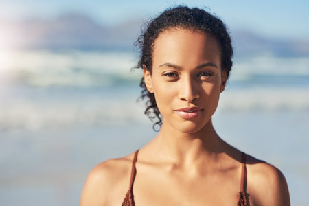 Its not summer without a beach day. a beautiful young woman spending the day at the beach.の写真素材