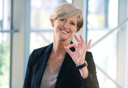 I have nothing but praise for you. Portrait of a mature businesswoman showing an ok sign in an...