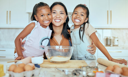 Baking, mother and children in kitchen, happy and smile together, bonding and child development. Portrait, mama and girls learn skills, loving and child care for fun, joyful and daughter at home.の写真素材