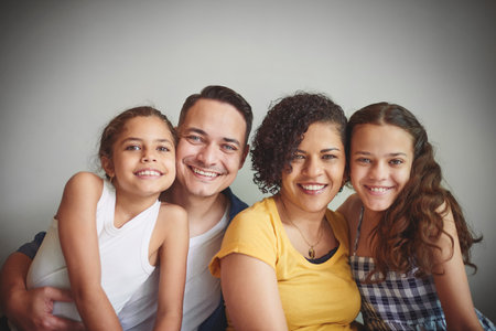 We cant imagine life without our girls. Portrait of a happy young family spending quality time together.の写真素材