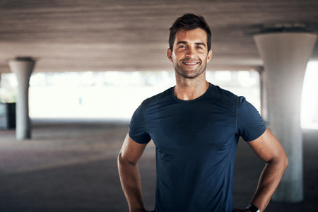 Its amazing how far youll get with a little determination. Portrait of a sporty young man exercising outdoors.の写真素材