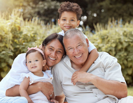 Family, children and happy grandparents bonding together outdoor with a baby and smile in nature....