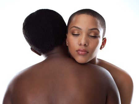 You can lean on me whenever you want. Studio shot of two beautiful young women holding each other while standing against a grey background.の写真素材