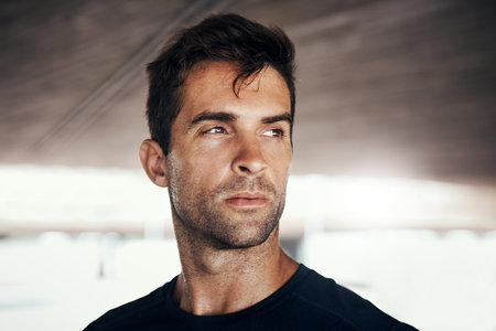 Youll earn nothing by quitting. a sporty young man exercising outdoors.の写真素材