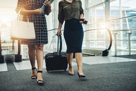 From here great partnerships begin. two unrecognizable businesswomen walking together with their bags in a modern workplace.の写真素材