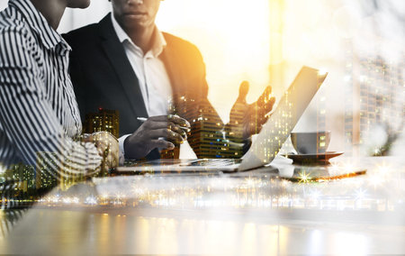 Working from concept to completion. Closeup shot of two businesspeople working together on a laptop...