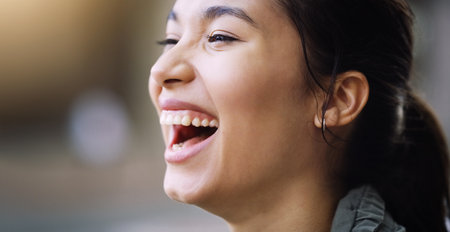 Shes such a cheerful spirit. Closeup shot of a cheerful young woman enjoying herself outdoors.の写真素材