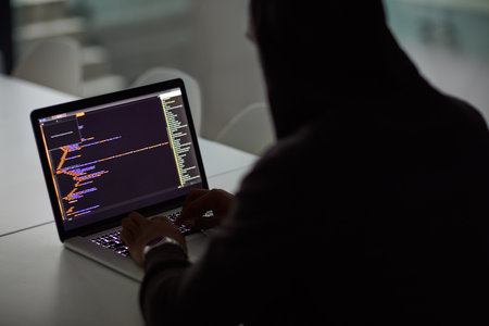 Manipulating your info with malicious intent. an unrecognisable hacker using a laptop.の写真素材