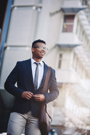 This city presents so many opportunities. a handsome young businessman in the city.の写真素材