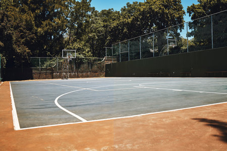 Sports, basketball court and nature, outdoor park and space for youth to exercise, workout and play in summer. Basketball, fitness and health, playground with trees and motivation for playing game.の写真素材