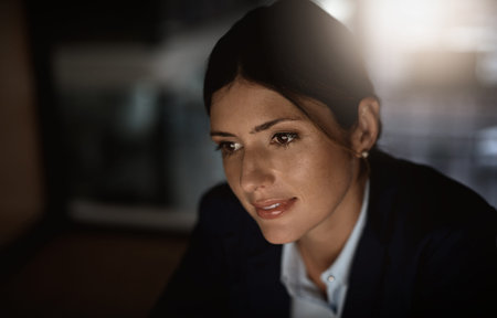 Success is a daily and nightly commitment. a young businesswoman working online during a late night...