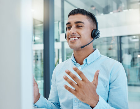 Call center, communication and man with support, help and advice for people with a computer in an...