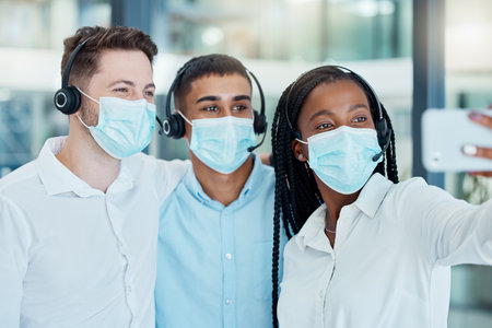 Call center, face mask and office selfie with telemarketing, CRM and customer support team during covid. Diversity group of men and woman during covid 19 for customer service for contact us websiteの写真素材