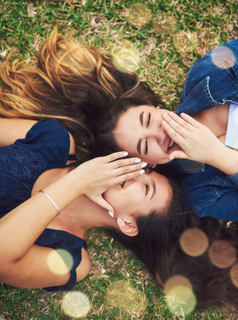 Living life and laughing all the way. High angle shot of two female best friends spending the day in...