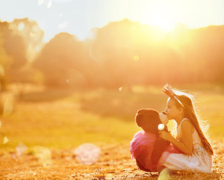 You are my best friend forever. an adorable little girl playing with her teddybear outdoors.の写真素材