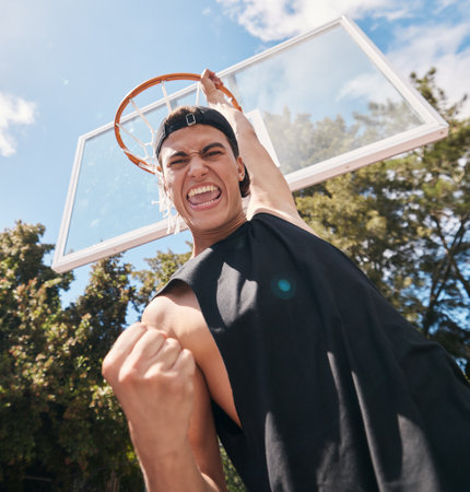 Basketball, man and winner in score for sports game, celebration or match in the court outdoors. Excited, energetic male basketball player celebrating victory dunk or sport success for point outsideの写真素材