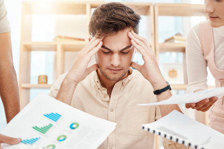 Stress, young man and headache being overworked, upset and tired in office. Business, employee and...