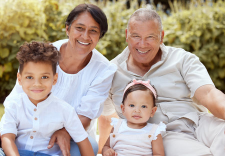 Family, children and grandparents with a girl and boy spending time together in the garden during a...