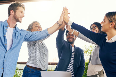 No matter what, well always come out on top. a group of businesspeople high fiving during a meeting...