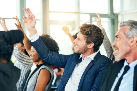 All questions are welcomed. a group of businesspeople sitting with their hands raised in a...
