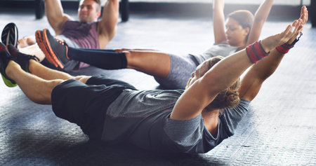 Uplift your day with a gym session. a group of young people working out together in a gym.