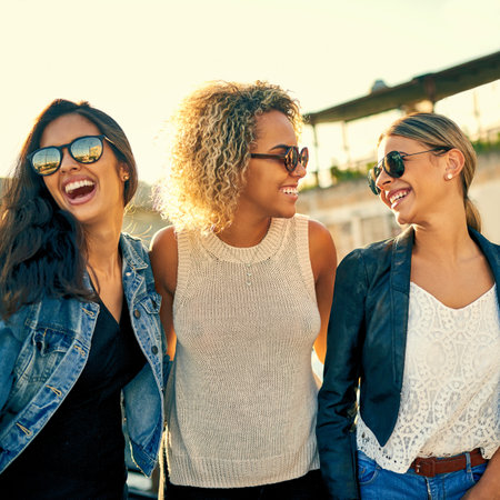Because in the end all we got is each other. three female best friends spending the day outside on a rooftop.の写真素材