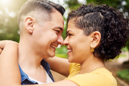Its true love. an affectionate young couple standing face to face outside in the park.の写真素材