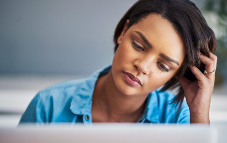 One of those go away days. an attractive young woman experiencing stress while using a laptop at...