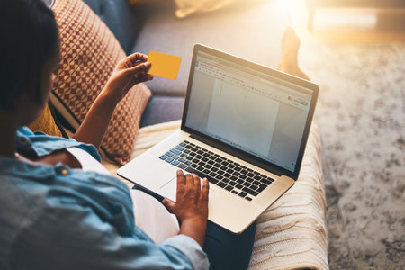 Theres something online for every stage of pregnancy. a pregnant woman using a laptop and credit...